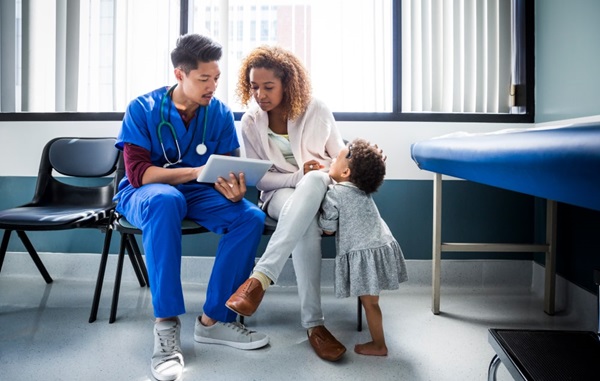 Doctor speaking with patient with child