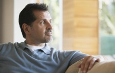 Man looking relaxed but pensive looking out a window